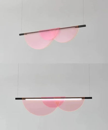 Pink iridescent acrylic petal pendant light shown in two views — warm pink glow and cool white light modes — suspended against a grey wall, demonstrating the dual color LED light source — LivDecor