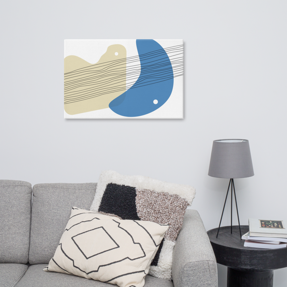Sand & Sea abstract canvas print in 24×36 hung large above a grey sofa with textured mixed cushions beside a black tripod floor lamp in a Scandinavian-style living room — LivDecor
