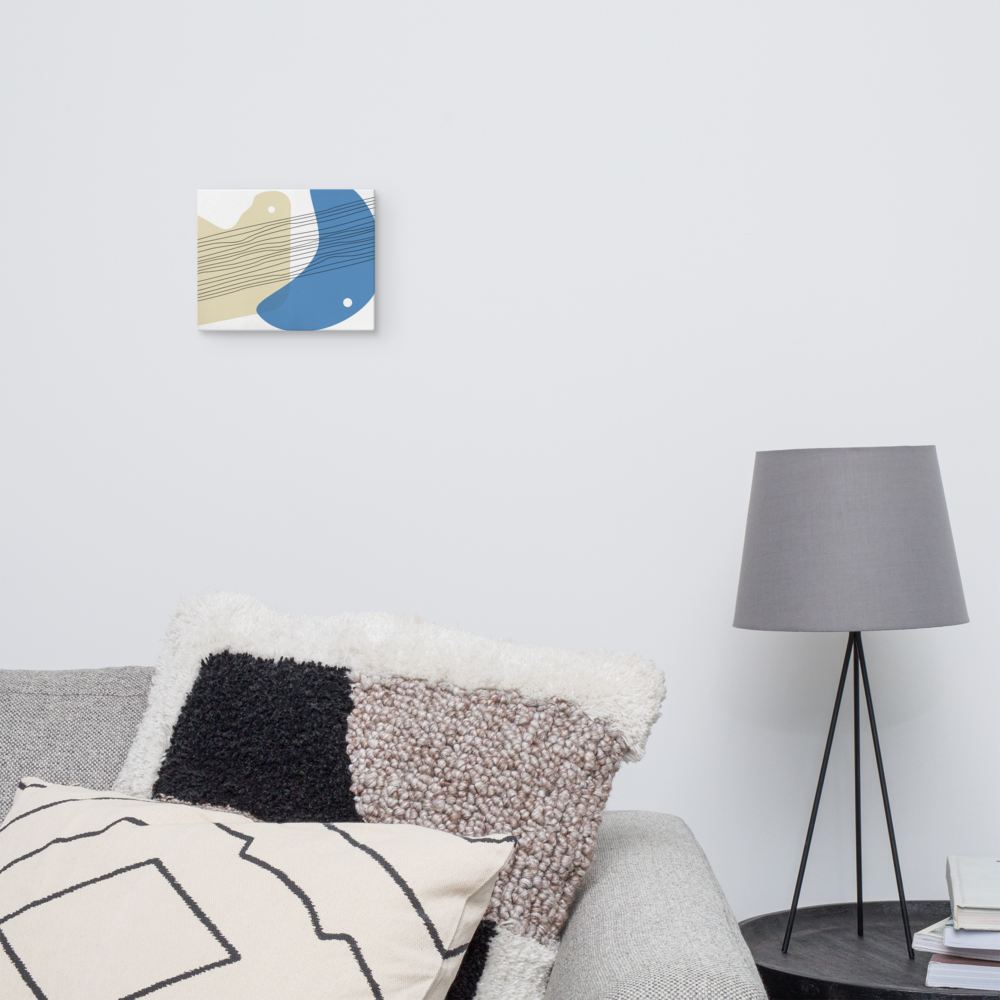 Sand & Sea abstract canvas print in 8×10 hung above a grey sofa with textured mixed cushions beside a black tripod floor lamp in a Scandinavian-style living room — LivDecor

