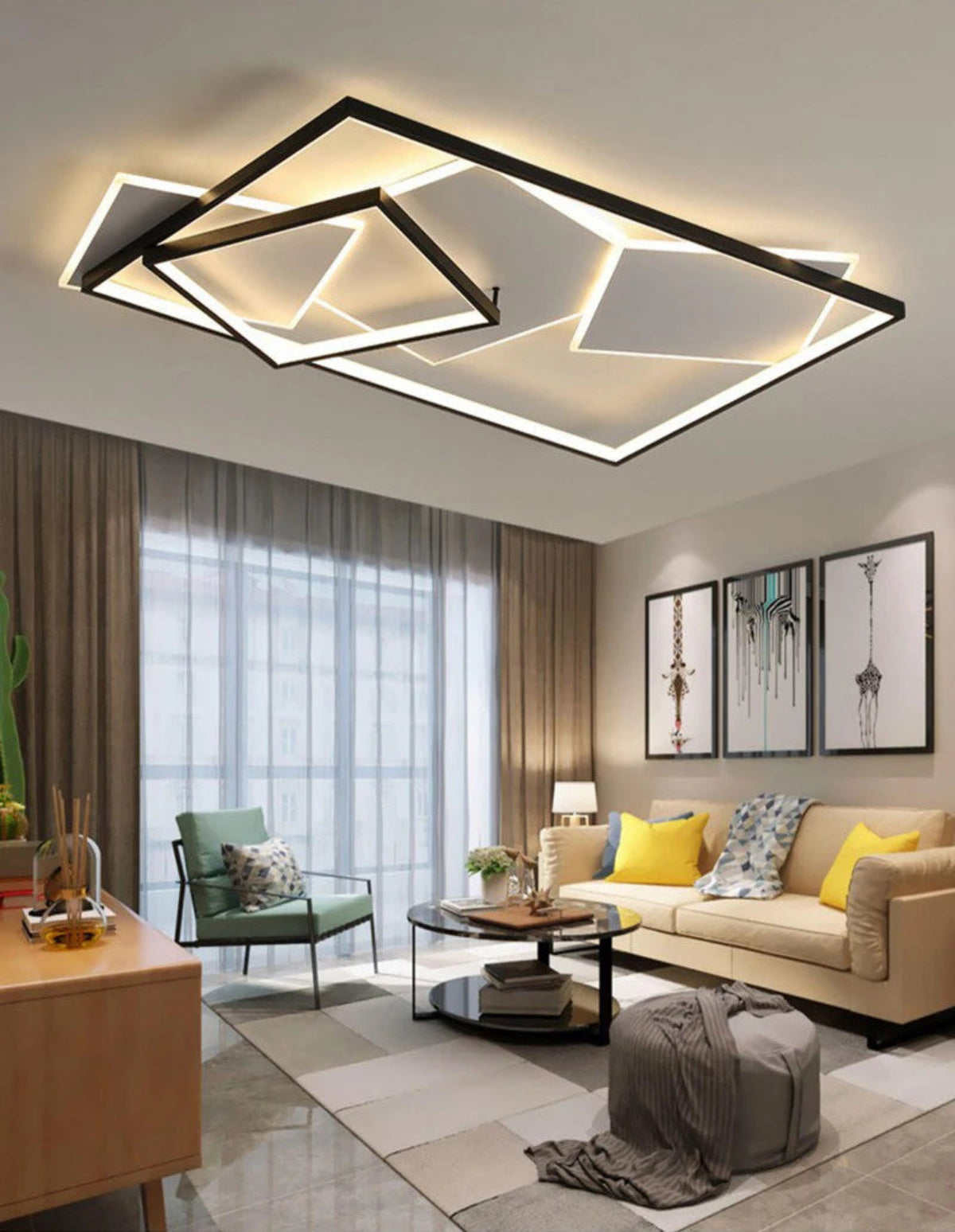 Strata Linear geometric LED chandelier in matte black glowing warm amber in a modern living room with cream sofa, yellow cushions, sage green armchair, and floor-to-ceiling curtains — LivDecor
