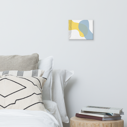 Sun & Shore abstract canvas print in 8×10 hung on a white bedroom wall beside a wood stump nightstand with stacked books and neutral linen bedding — LivDecor
