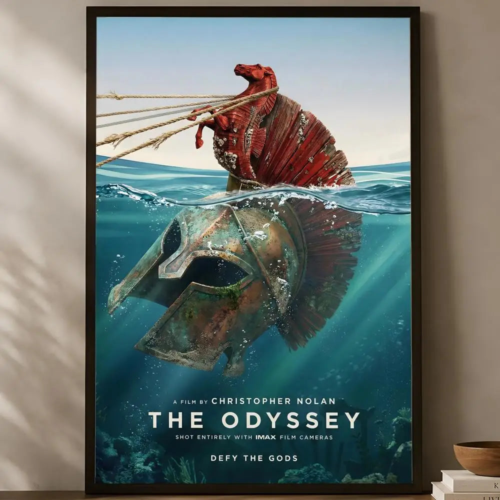 The Odyssey Christopher Nolan IMAX split above and below ocean view Greek ship above sunken warrior helmet below defy the gods cinematic poster displayed on a warm natural light shelf — LivDecor
