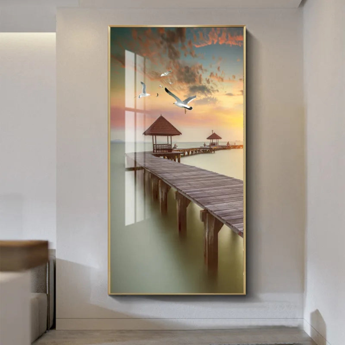 Tropical boardwalk with gazebo at sunset canvas wall art in a gold frame hung on a white wall, seagulls soaring over a warm glowing sky — LivDecor

