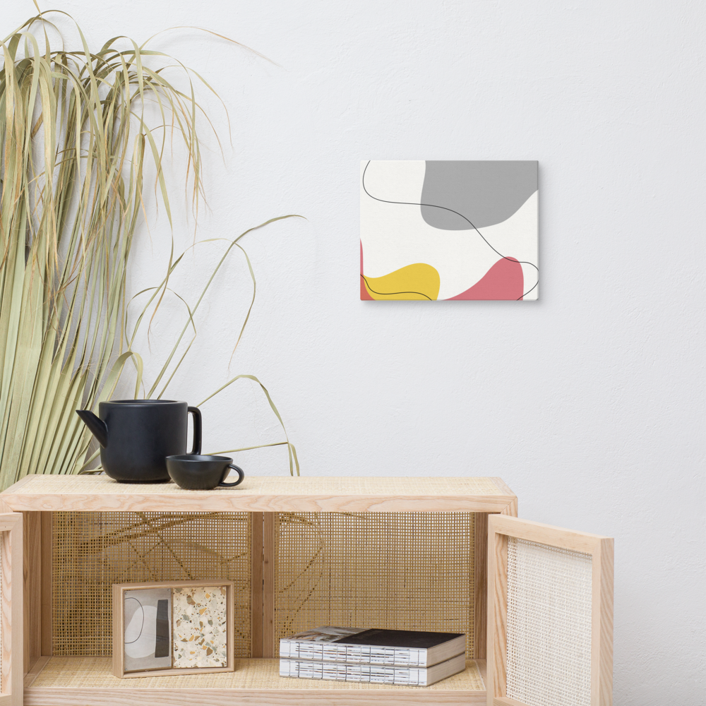 Warm Tide abstract canvas print in 11×14 hung above a rattan cane cabinet styled with a black ceramic tea set and dried pampas grass in a warm boho living space — LivDecor
