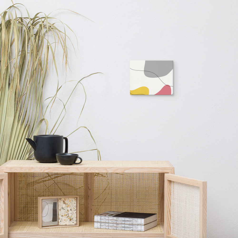Warm Tide abstract canvas print in 8×10 hung above a rattan cane cabinet styled with a black ceramic tea set and dried pampas grass in a warm boho living space — LivDecor
