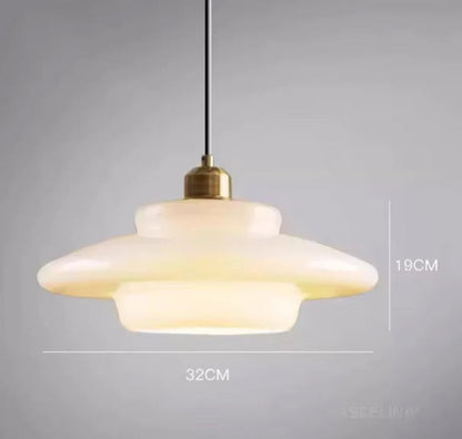White glass saucer-shaped tiered pendant light measuring 32cm wide by 19cm tall with a brass fitting and black cord, shown with dimensions on a grey background — LivDecor